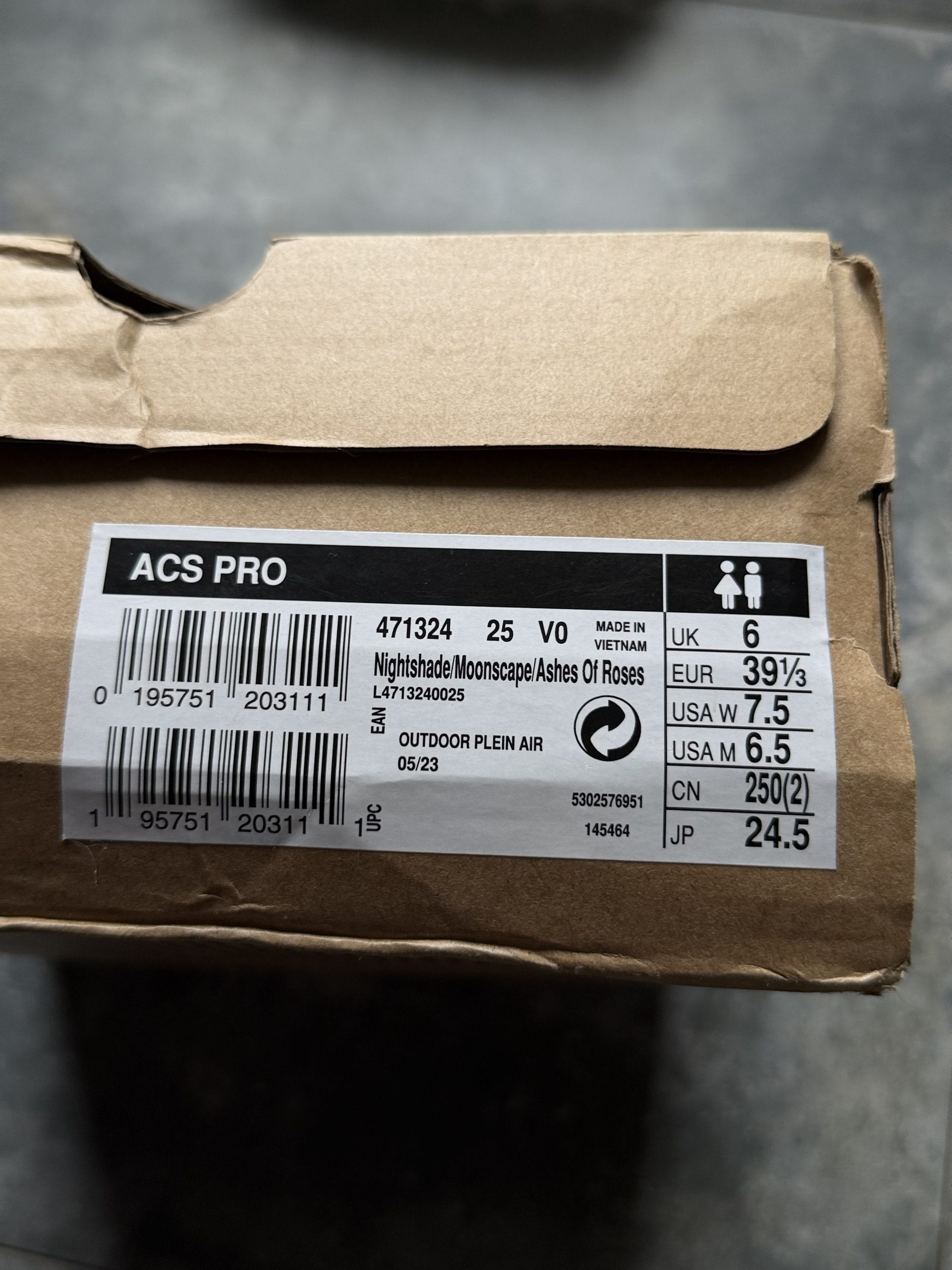Brown cardboard box with a white product label reading 'ACS PRO' and size information (UK 6, EU 39 1/3, USA 7.5); label also lists 'Nightshade/Moonscape/Ashes Of Roses'.