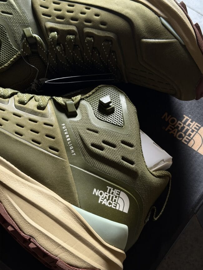 Close-up of an olive-green The North Face hiking boot showing laces, breathable upper panels, and Futurelight label.